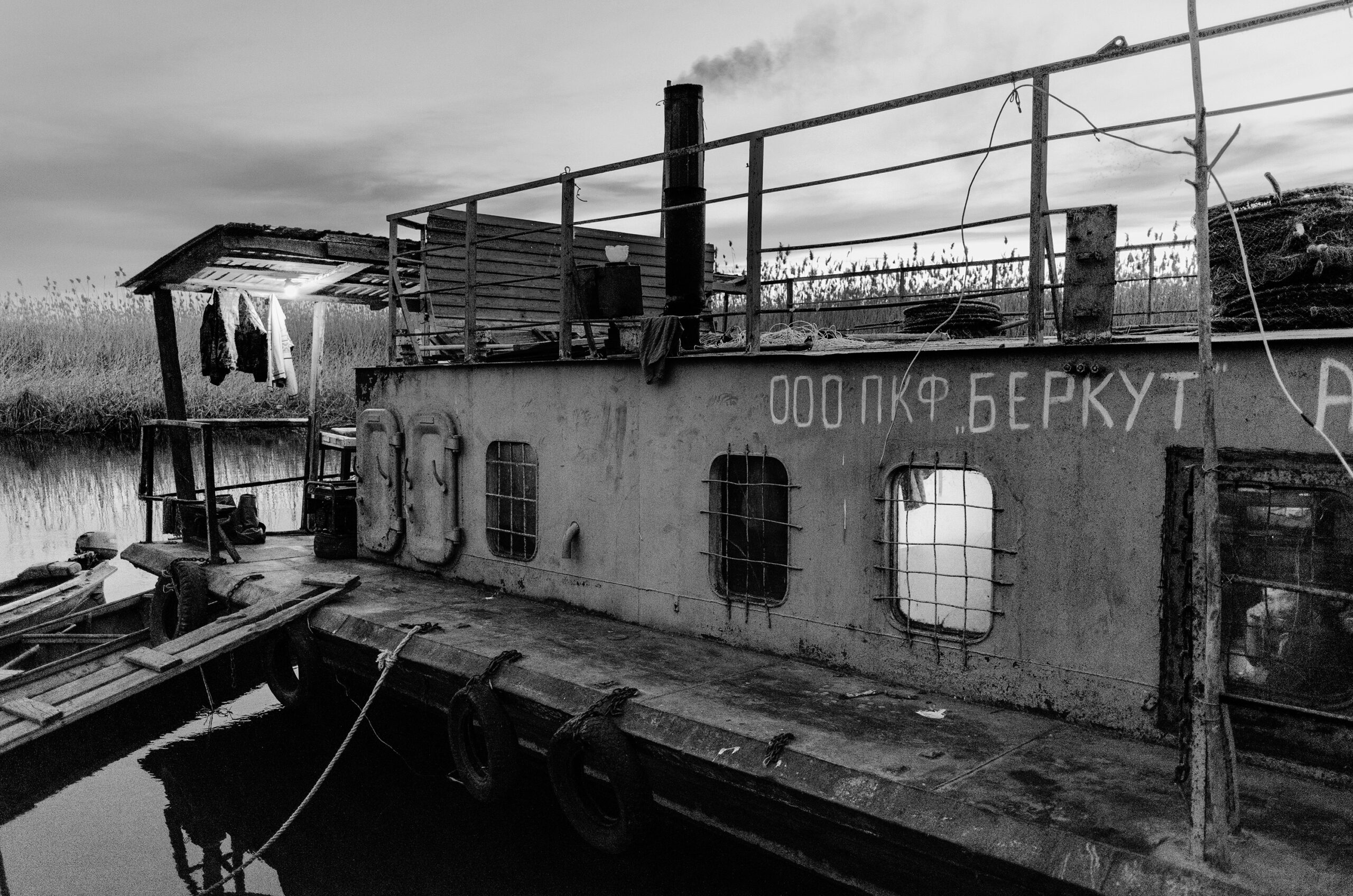 man peeks out of ship port