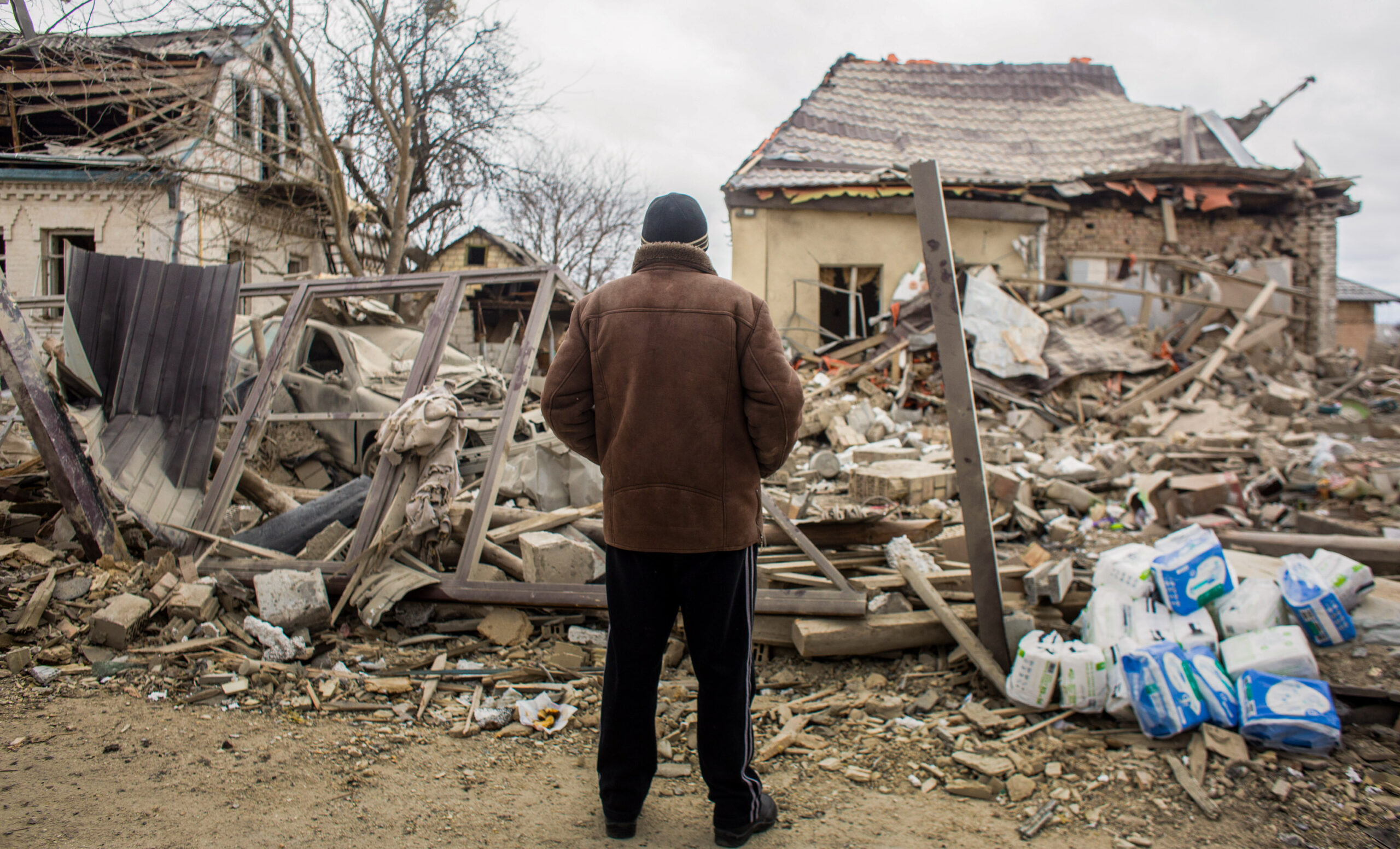 Local resident looks at a shelled area on March 5, 2022 in Markhalivka, Ukraine.