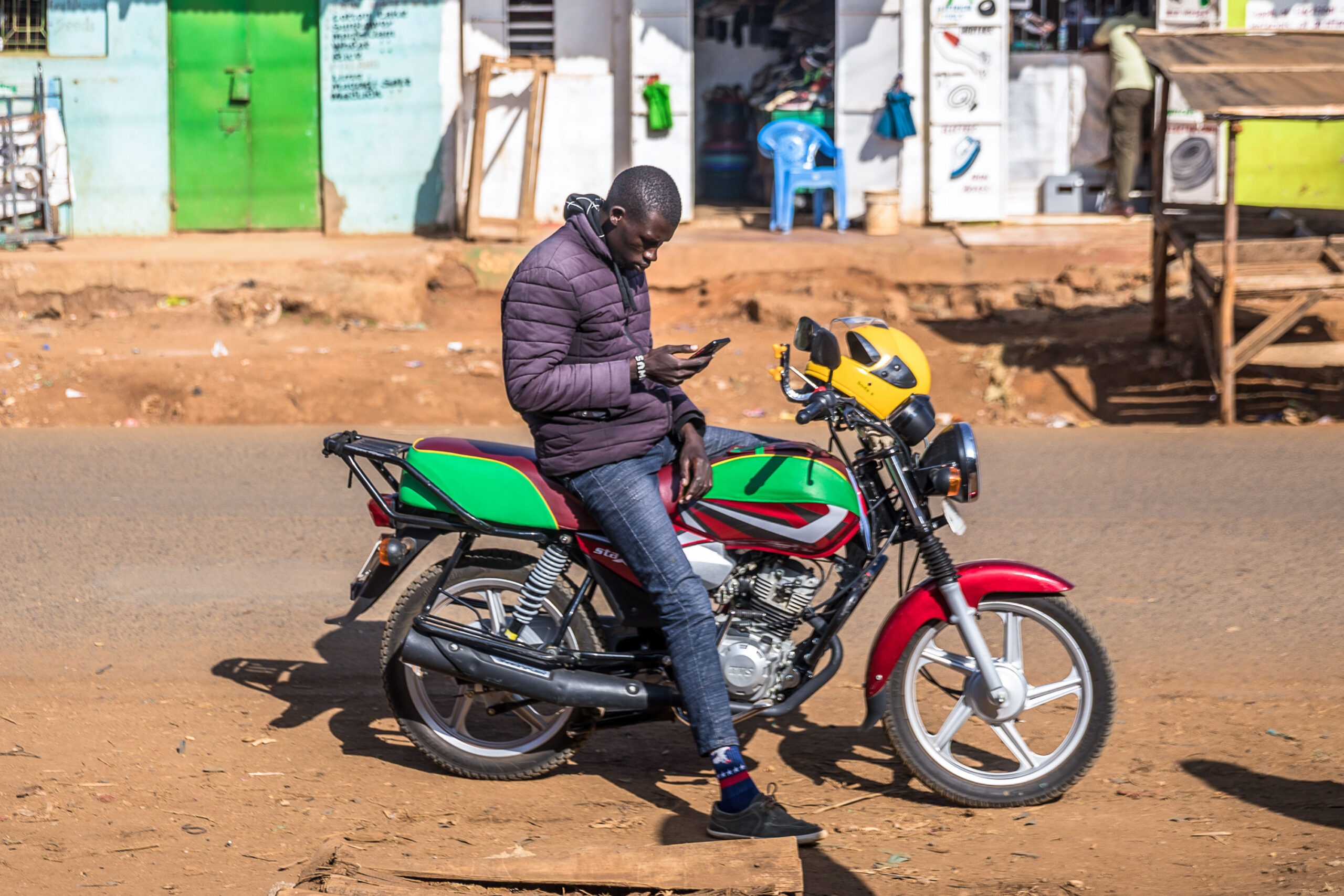 A motorcycle rider on his phone in Eldoret, Kenya