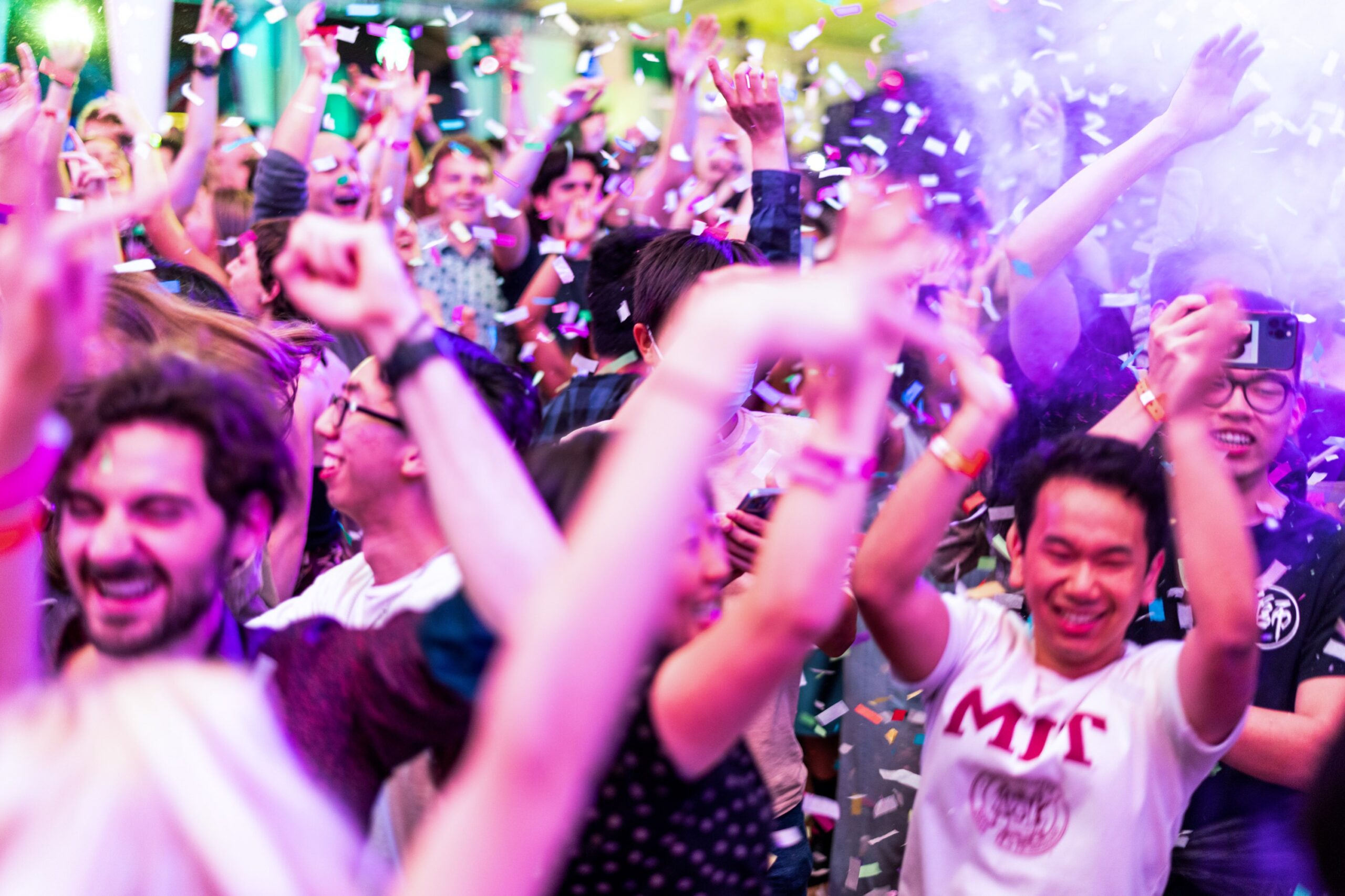 partygoers with confetti and colored lights
