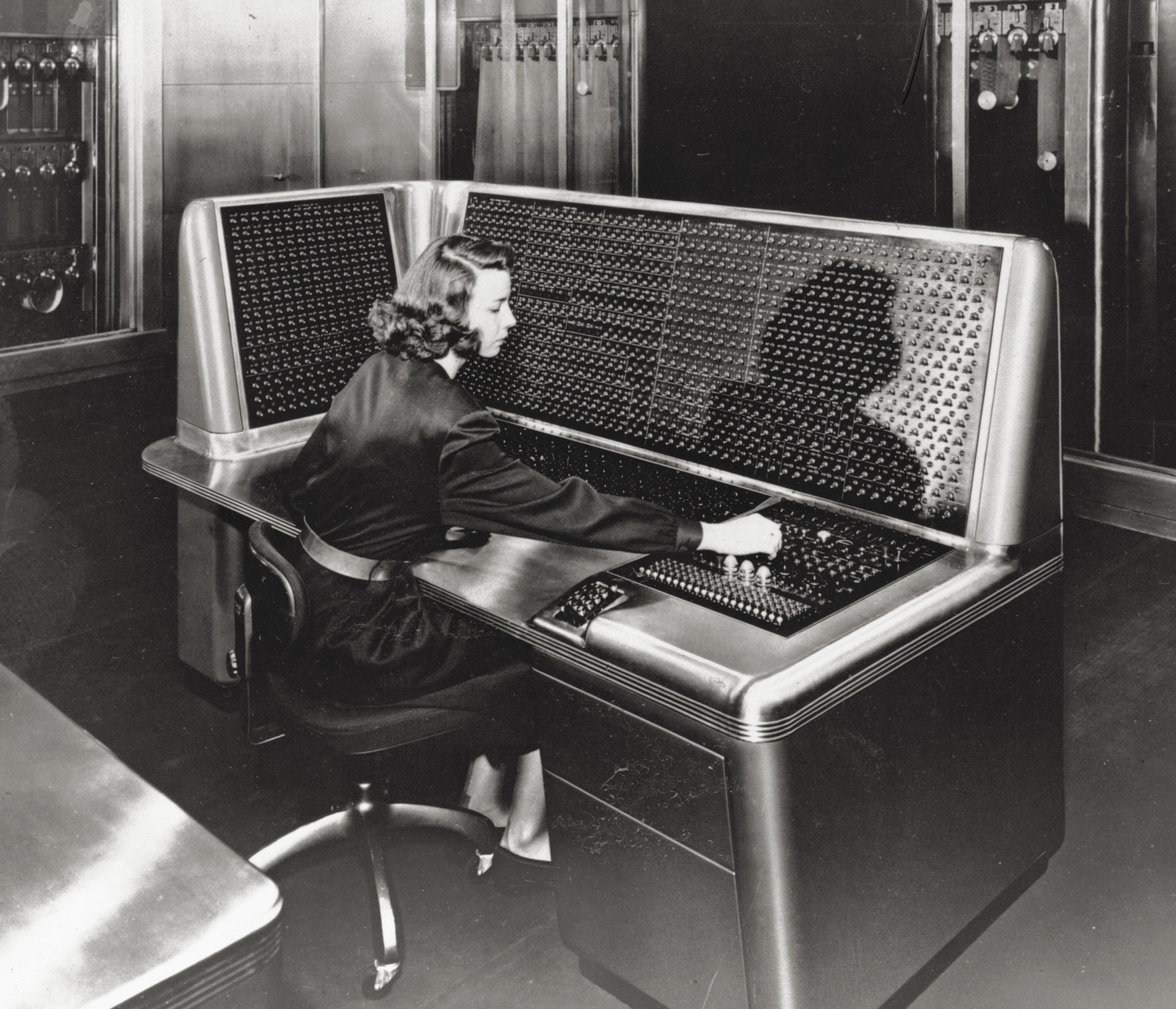 woman sitting at a control desk
