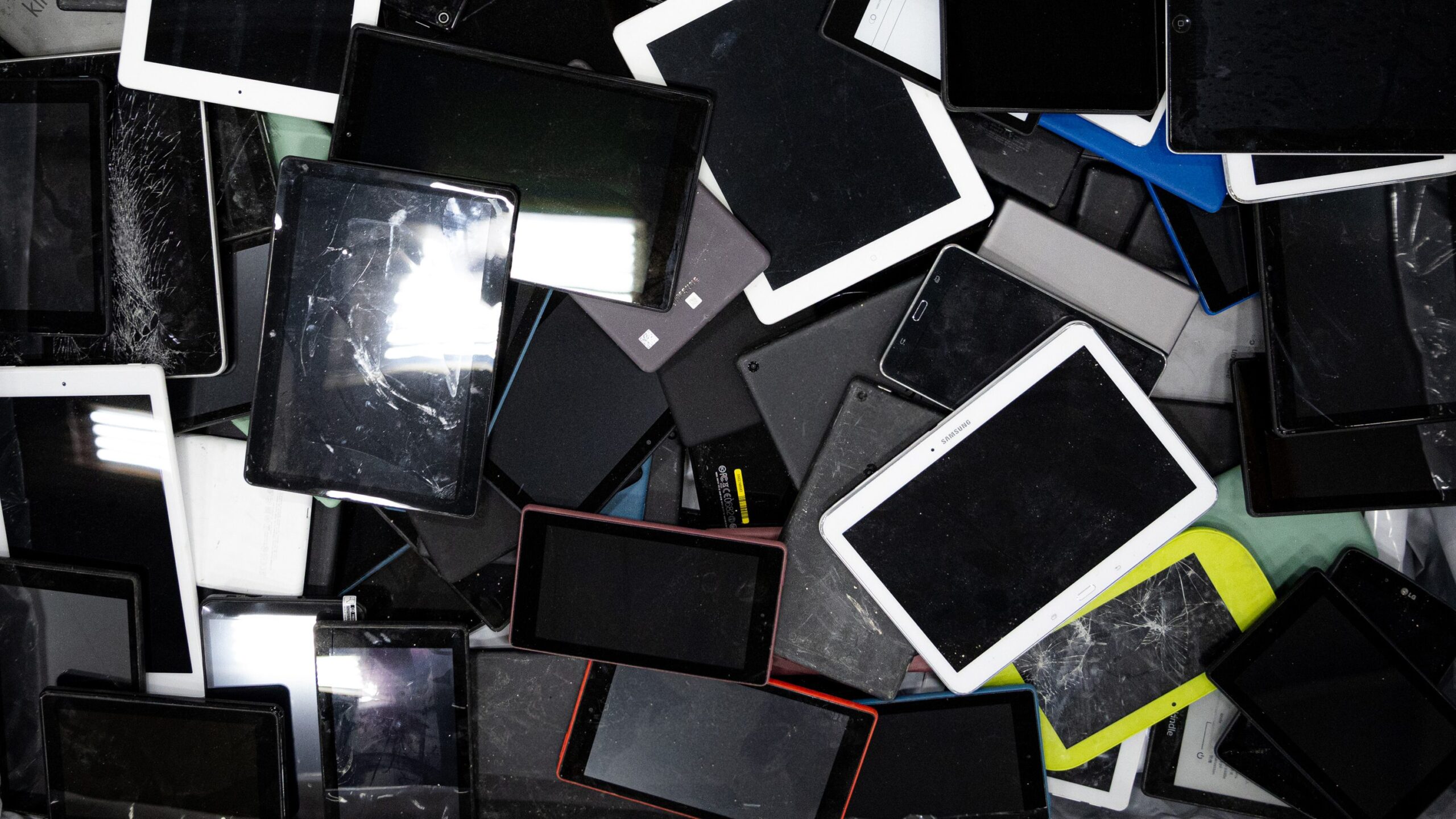 pile of broken tablets and phones