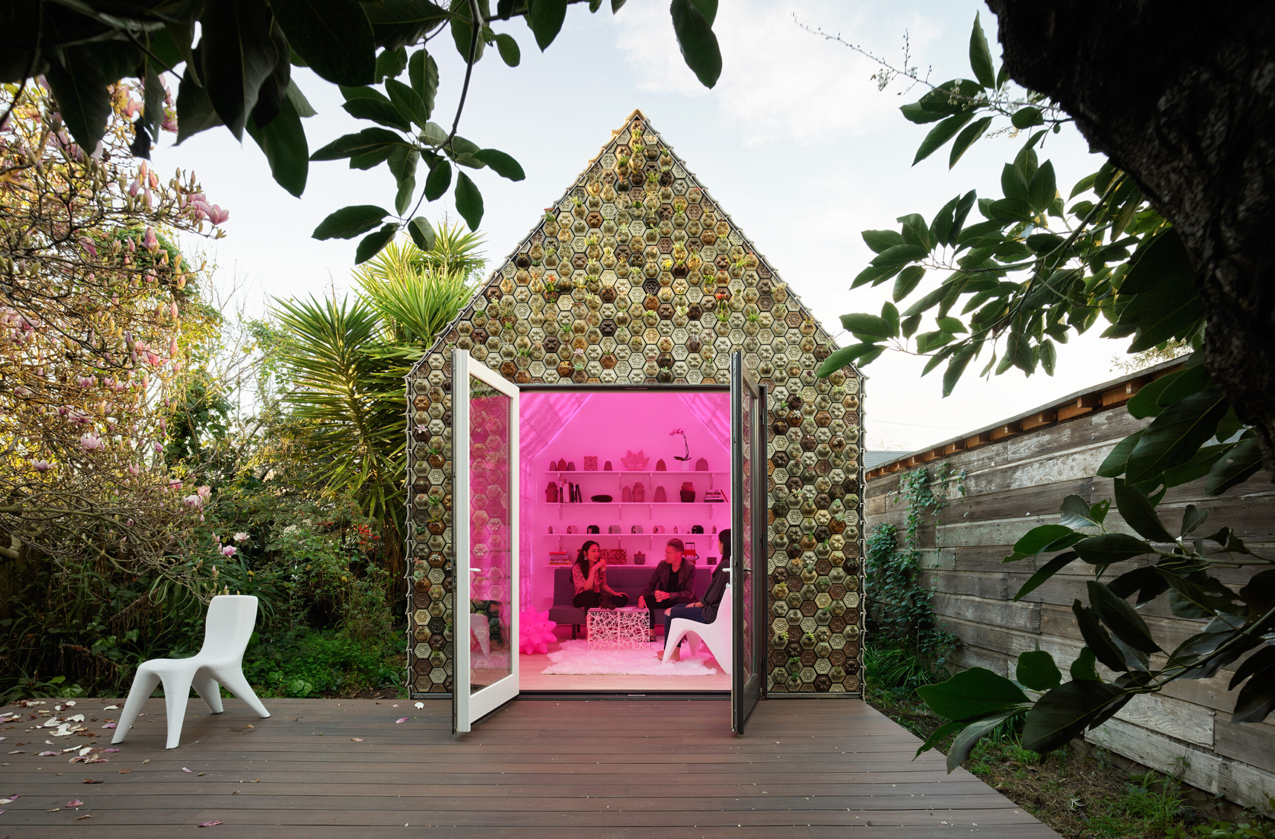 people relaxing in a 3D printed cabin