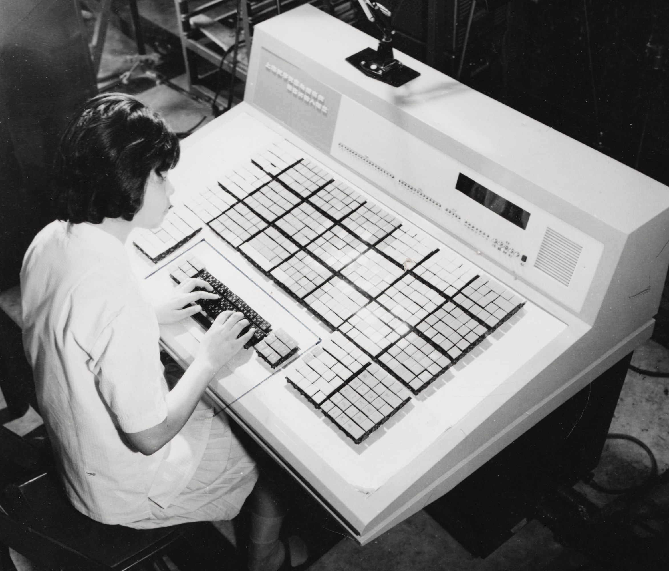 woman using a large desk-sized terminal