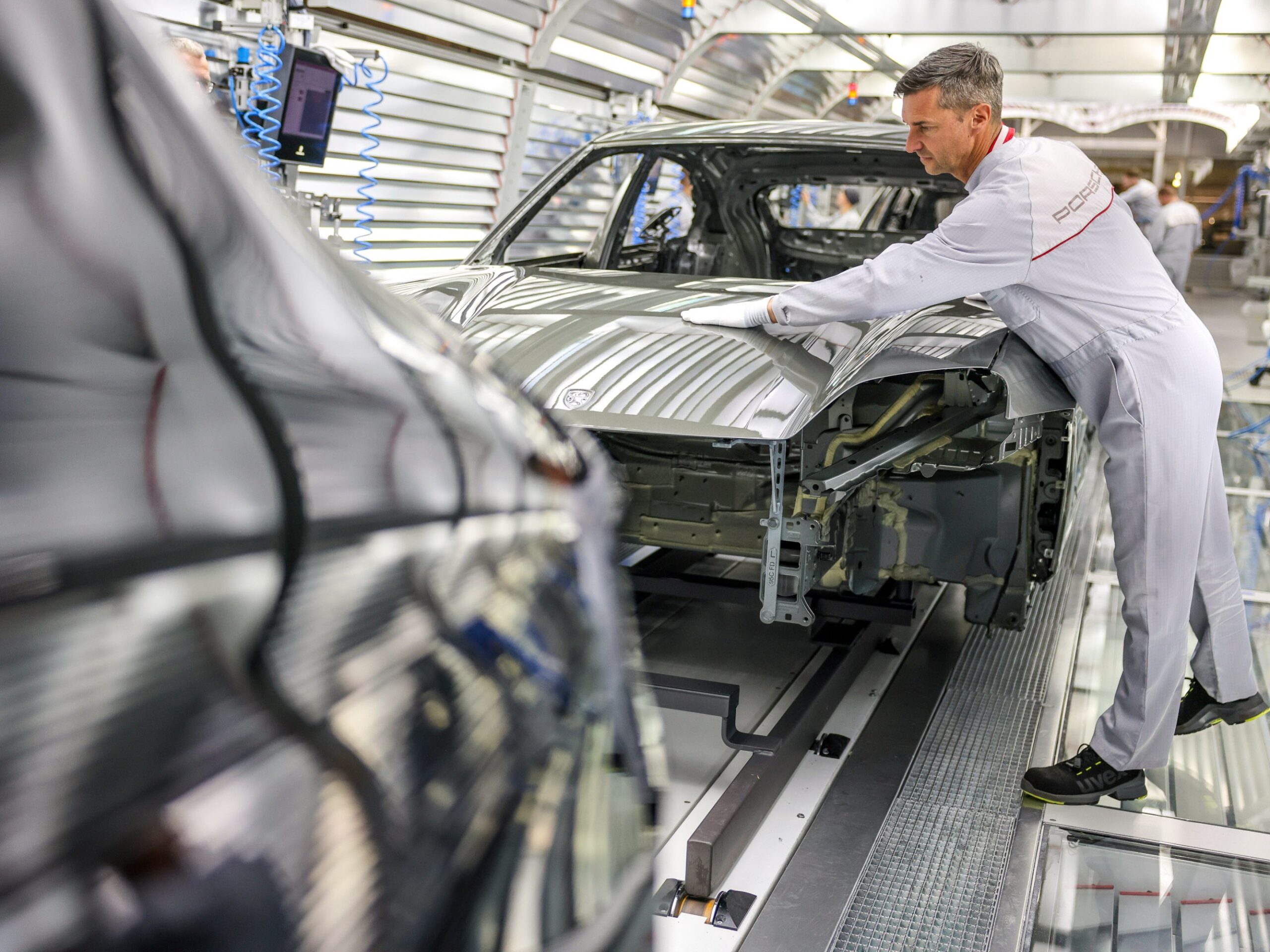 A Porsche employee at the assembly line