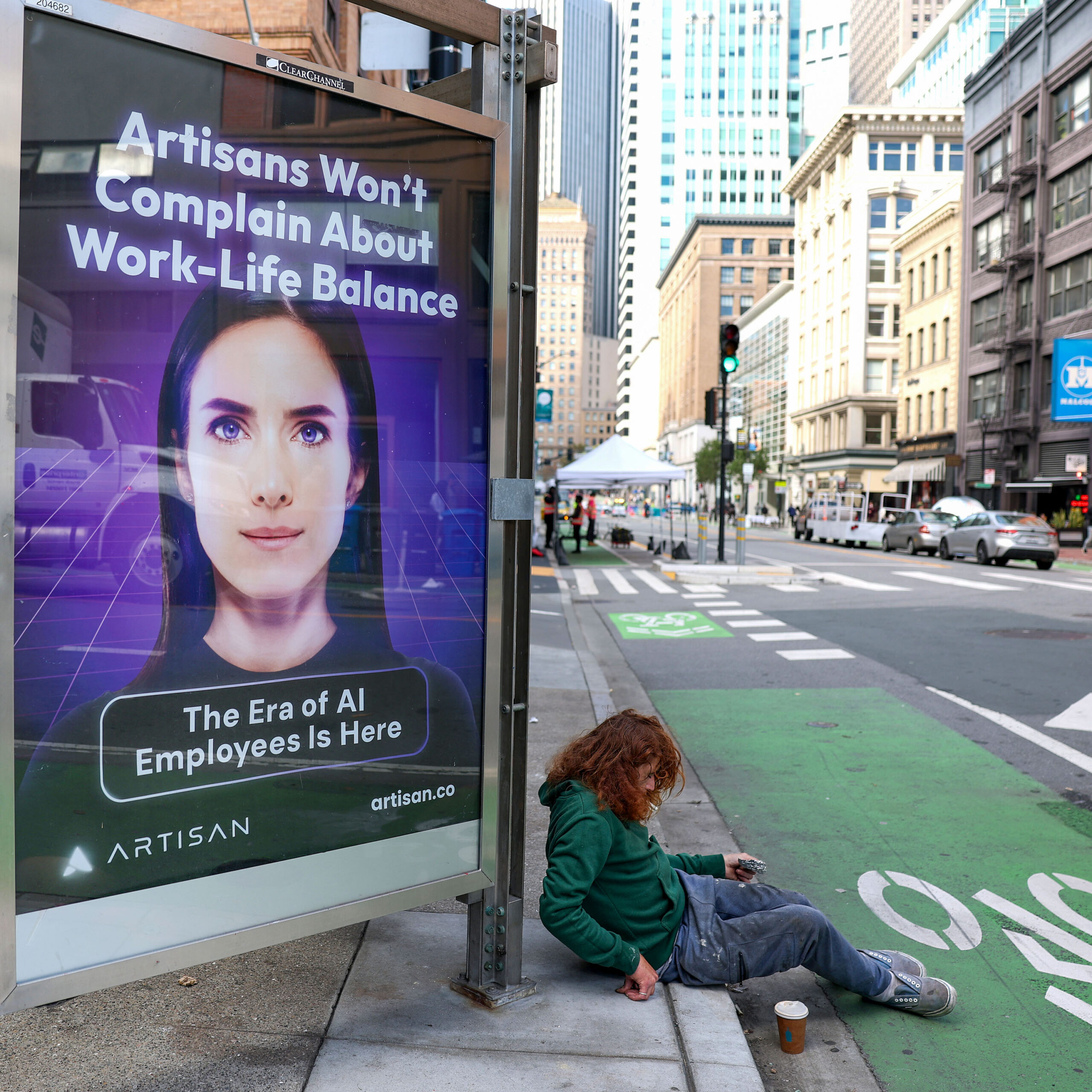 a person laying in the sidewalk next to a bus sign reading, "Artisans won't complain about Work-Life balance. The era of AI employees is here."