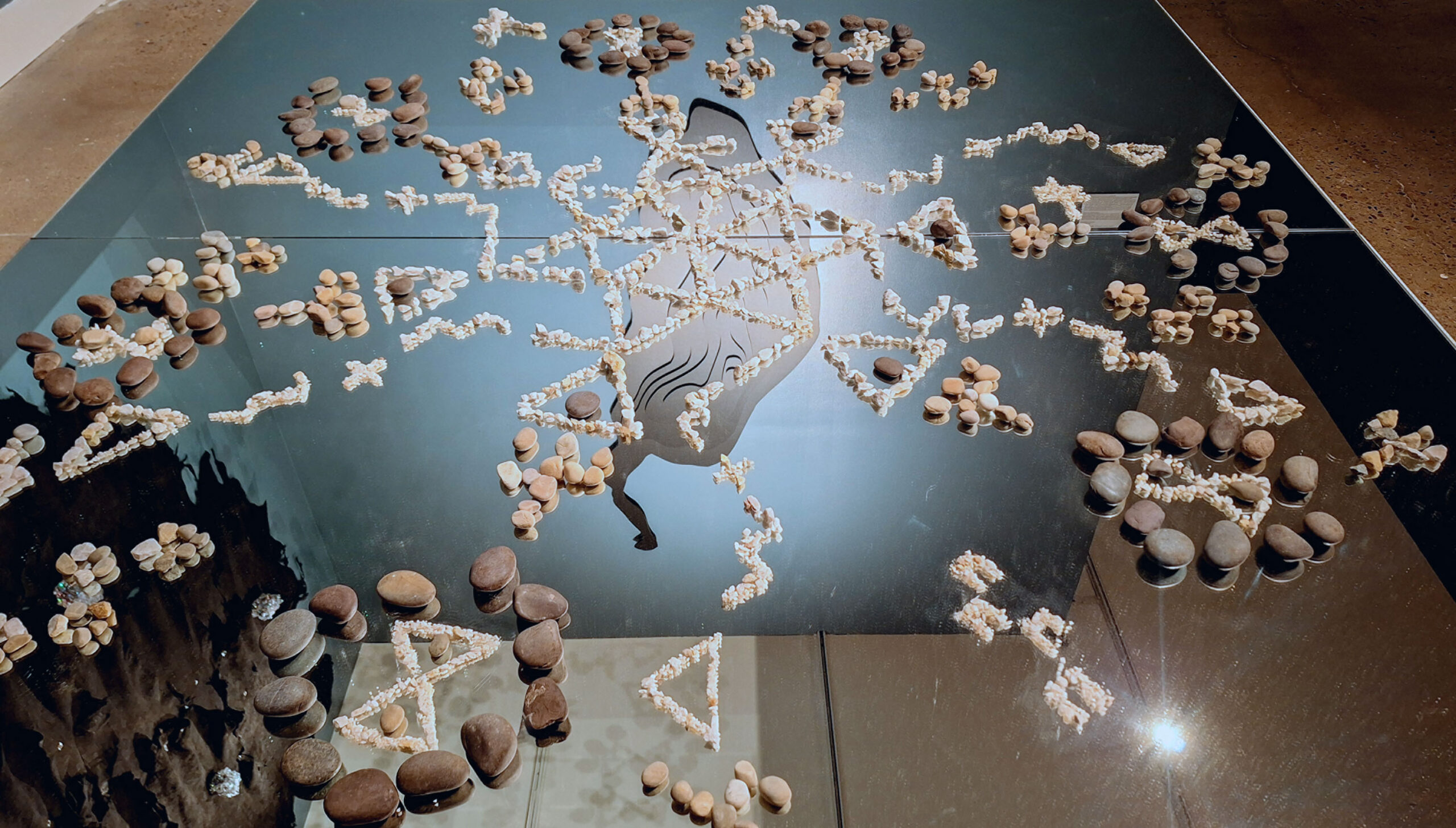 stones arranged on a reflective surface